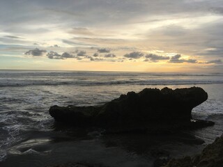 Golden Sunset in a tropical beach With sand, Horse and rock