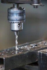 Industrial drilling machine drills a hole in the metal. Metal processing machines.