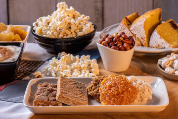 June party. Typical sweets from festa junina. Cornmeal cake, popcorn, hominy, paçoca, cocada, pumpkin jam, and peanuts
