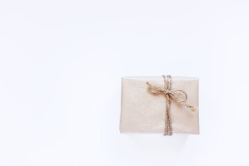 Eco gift box wrapping in kraft paper on white background isolated. Vintage eco-friendly natural style. Top view composition,New year holiday flatlay,copy space