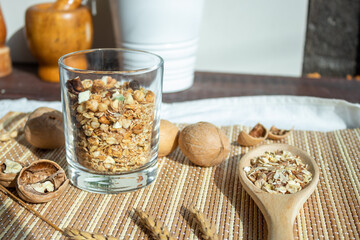 Useful muesli with nuts in a glass on the table. Healthy lifestyle