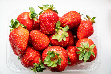ripe sweet strawberries in container. seasonal berries. healthy tasty food.