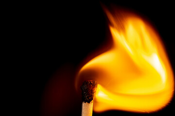 Burning match isolated on black background. Macro. Close up. Fire.