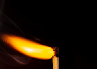 Burning match isolated on black background. Macro. Close up. Fire.