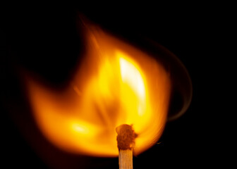 Burning match isolated on black background. Macro. Close up. Fire.