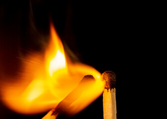 Burning match isolated on black background. Macro. Close up. Fire.