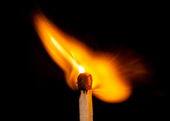 Burning match isolated on black background. Macro. Close up. Fire.