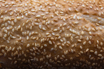 crispy long fresh french baguette with sesame seeds close-up macro