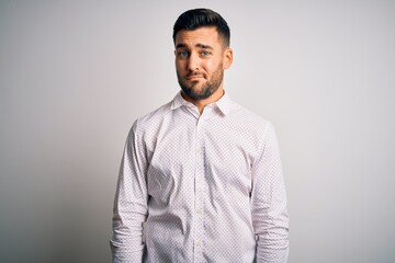 Young handsome man wearing elegant shirt standing over isolated white background looking sleepy and tired, exhausted for fatigue and hangover, lazy eyes in the morning.