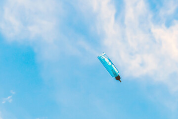 Antiseptic alcohol bottle floating on blue sky background, Campaign to prevent the spread of the Corona virus (Covid-19). New normal concept.
