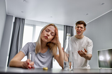 young caucasian man live with worthless wife alcoholic, he is tired of life with her, argue at home