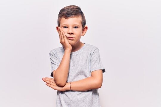 Cute blond kid wearing casual clothes thinking looking tired and bored with depression problems with crossed arms.