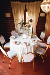 Wedding table setting with empty wine glasses and fresh flowers