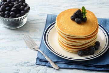 blueberry pancakes on a plate with a fork