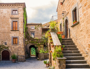 Fototapeta na wymiar Idyllic inner alley of Civita di Bagnoregio, ghost mediaeval town built above a plateau of friable volcanic tuff, Lazio, central Italy 