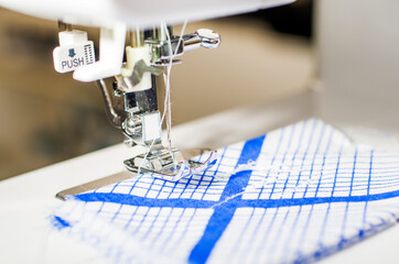 Sewing machine. Handmade work. Textile factory. Sewing machine sews fabric.