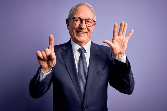 Grey haired senior business man wearing glasses and elegant suit and tie over purple background showing and pointing up with fingers number six while smiling confident and happy.