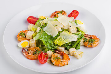 Caesar salad with prawns and parmesan cheese, croutons, tomatoes 