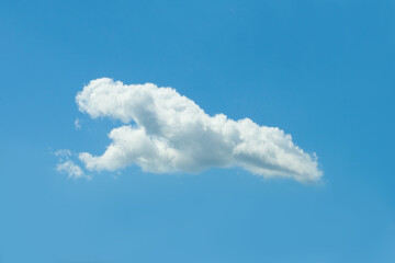 Blue sky background with one white cloud.