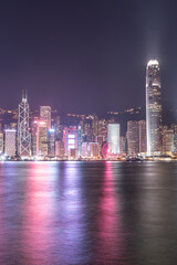 The incredible night cityscape view of lights on the water on Victoria Harbour in Hong Kong
