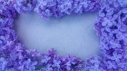 Lilac flowers on blue textured background. Spring flowers. Top view, flat lay. Spring concept with copy space.