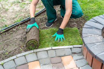 Landscape Gardener Laying Turf For New Lawn