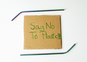 Photo of a paperboard with the message Say No to plastic with two reusable straws. Zero waste...