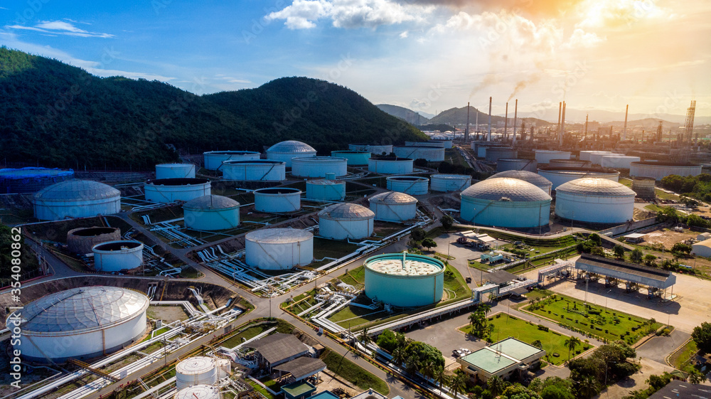 Wall mural aerial view of a lot of oil depot gas storage tank infront of oil refinery tower in the morning for 