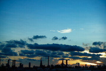 silhouette city scape at bottom, beautiful sky and clouds in the evening, selective focus