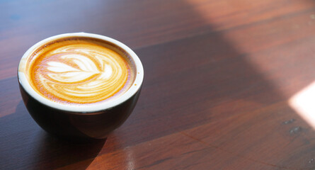 hot late coffee in black cup with sun light in the morning, copy space at right