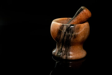 A mortar on black background with reflection.