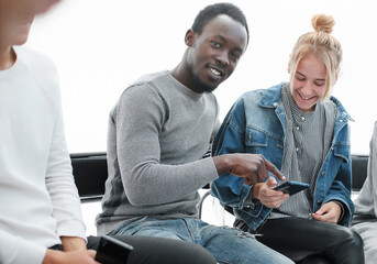 close up. young people reading information on their smartphones