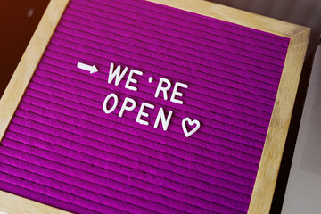 # Reopening plan text on purple letter board near the notebook. Business concept. Service,...