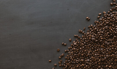 coffee bean on black wooden floor background. top view. space for text