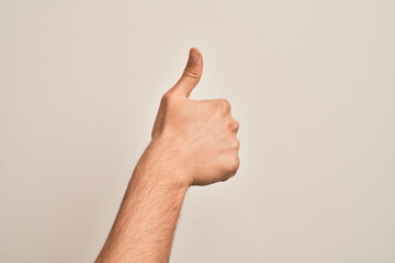 Hand of caucasian young man showing fingers over isolated white background doing successful approval gesture with thumbs up, validation and positive symbol