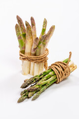 Green and white fresh asparagus on a gray background