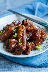 sweet and sour pork ribs in a plate under natural light
