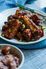 sweet and sour pork ribs in a plate under natural light