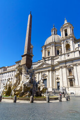 Naklejka na ściany i meble Fountain of the Four Rivers with an Egyptian obelisk and Sant Agnese Church on the famous Piazza Navona Square in the morning, Rome, Italy