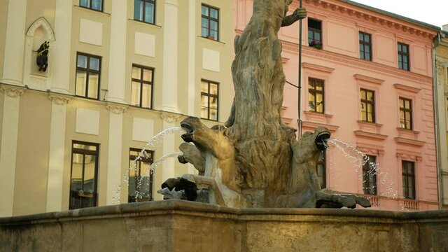 Neptune Fountain statue sculpture robust figure landmark historical monument memorial 1683, depicts Roman god of seas, baroque style trident, tank water spouting spring, architecture city Olomouc