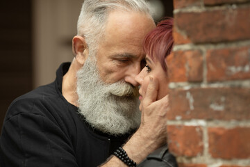 Bearded Senior man and woman wearing leather jackets. Happy couple of retirees in biker clothes.