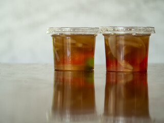 Jelly is packaged in plastic glass.