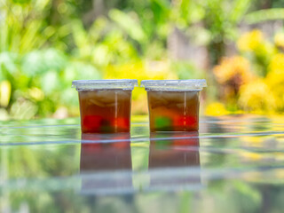 Jelly is packaged in plastic glass.