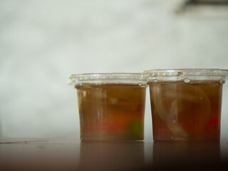 Jelly is packaged in plastic glass.