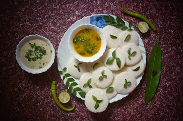 Idli and smabhar garnished with herbs and spices