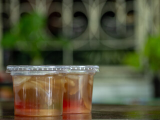 Jelly is packaged in plastic glass.