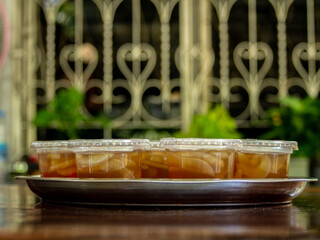 Jelly is packaged in plastic glass.