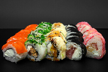Large set of Delicious sushi rolls. A lot assortment Philadelphia roll Dishes from Japanese raw fish. Japan food menu service