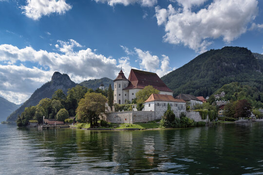 Iconic view from Lake Traunsee to parish church and former monastery of Traunkirchen, alpine mountains in background, Salzkammergut, Upper Austria, Europe