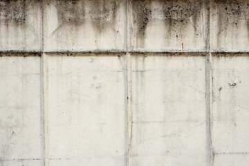 Grey old concrete wall with cracks and rectangular relief pattern. Concrete texture, space for text and layout for design.